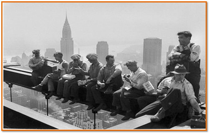 Construction workers take a lunch break on a steel beam atop the building at Rockefeller Center